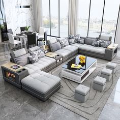 a modern living room with grey couches and white tables in front of large windows