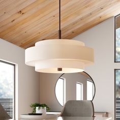 a white table and chairs in a room with wood ceilinging, round mirror on the wall