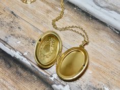 This gold oval locket necklace is a great keepsake necklace. It opens for your favorite two photographs. You will need to find a photo that fits and glue it into place. We do not place the photo in for you and at this time we do not engrave. It's the perfect gift for all ages. These lockets are not vintage, they are new. Unfortunalty it is very difficult to find vintage lockets. I T E M • DETAIL: - PENDANT SIZE: Outside measurements 7/8" x 1 1/4", Inside measurement 5/8 x 7/8 - CHAIN LENGTH: 16" Gold Oval Pendant Locket Necklace For Keepsake, Cameo Oval Pendant Locket Necklace Gift, Cameo Locket Necklace As Gift, Oval Cameo Locket Necklace Gift, Gold Oval Locket Necklace For Keepsake, Oval Pendant Locket Necklace For Keepsake, Oval Locket Necklace For Personalized Gifts, Gold Oval Pendant Locket Necklace For Personalized Gift, Gold Oval Locket Necklace For Personalized Gift