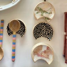 several bowls and spoons are arranged on a table