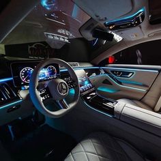 the interior of a modern car with blue lights