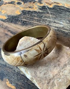 "Awesome vintage brass and bone bangle bracelet. This chunky boho bracelet features inlaid cream, tan and brown hues of carved design bone with brass frame. Great on its own or stacked with other bracelets   Measures: 2.5\" in diameter 3.0\" outside diameter 7/8\" width  In very good vintage condition. Please note: ALL the items in my shop are VINTAGE items and the majority are in VINTAGE pre-loved condition. I strive to describe each item as accurate as possible but please be sure to refer to p Bohemian Brown Brass Bracelets, Bohemian Brown Brass Bracelet, Vintage Beige Bracelet, Carved Brown Bangle Jewelry, Brown Carved Bangle Jewelry, Bohemian Cream Bangle Jewelry, Bohemian Cream Bangle, Vintage Cream Bangle Jewelry, Bohemian Carved Bangle Bracelet