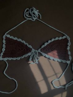 a crocheted bralet is shown on the floor