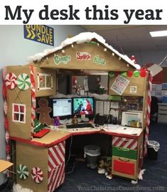 an office cubicle decorated for christmas with gingerbread house