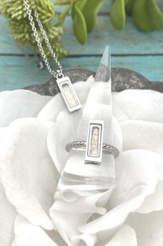 Save money by buying the set! These are such wonderful keepsakes to commemorate any loved one or any beloved pet. The necklace and ring are made from stainless steel so they are considered hypoallergenic and will not tarnish. The pendant comes on a 20" stainless steel chain. This dainty bar/rectangle measures approximately 16x6mm on both the ring and pendant. This pendant and ring can be filled with human or pet cremation ashes, sand, small flower petals, glitter, hair, fur, etc. These are made Cremation Ring, Locket Ring, Pet Urn, Pet Memorial Jewelry, Dainty Band, Necklace Matching, Pet Cremation, In Memory Of Dad, Urn Jewelry