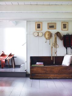 a living room filled with furniture and pictures on the wall