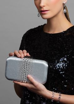 Add a hint of sparkle with this glamorous satin clutch — ELLA is adorned with the highest quality brilliant cut crystals to add the perfect touch of sparkle to any look. Perfect for pairing with a vibrant evening gown to bring out its designs, the Ella Crystal Clutch is a beautiful evening wear clutch with just enough detail to make the accents of your dress shine. Against a smooth and soft satin background layer are clear, sparkly crystals that are heavy in concentration and large in the center Elegant Crystal Embellished Clutch For Cocktail, Rhinestone Clutch For Gala, Luxury Embellished Clutch For Cocktails, Glamorous Crystal-embellished Clutch For Cocktail, Glamorous Evening Clutch With Sparkling Details, Glamorous Crystal Embellished Clutch For Cocktail, Glamorous Crystal Embellished Clutch For Cocktail Occasions, Glamorous Sparkling Clutch For Events, Glamorous Sparkling Evening Clutch