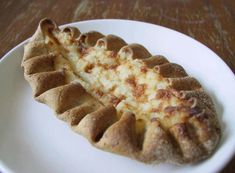 a piece of pizza sitting on top of a white plate