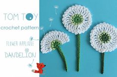 three crocheted dandelions on a blue background with the words tom toy