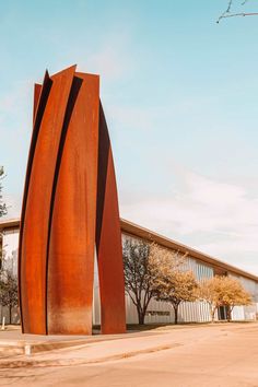 a large metal sculpture in front of a building