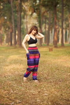 These cute hippie pants are colorful pants and handmade with rayon fabric which make them super comfy to wear. They have an elastic waist and elastic ankles. The two pockets are fitted with decorative strings. These trousers are are perfect for relaxing at home, working out, yoga running, beachwear and general casual wear. Also recommended for Thai massage, dance and festivals. Lannaclothesdesign products are uniquely designed and latest fashion trends. You can choose from many different colors Bohemian Summer Parachute Pants For Yoga, Bohemian Parachute Pants For Yoga In Summer, Bohemian Parachute Pants For Yoga And Summer, Hippie Harem Bottoms For The Beach, Casual Multicolor Harem Pants For Beach, Multicolor Ankle-length Harem Pants For Summer, Summer Multicolor Ankle-length Harem Pants, Colorful Bohemian Beach Bottoms, Multicolor Ankle-length Beach Pants