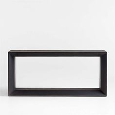 a black shelf sitting on top of a white floor