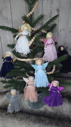 a small christmas tree decorated with angel ornaments