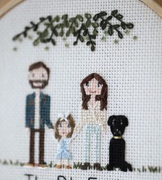 a cross stitch picture with the words family on it and an image of a man, woman and dog