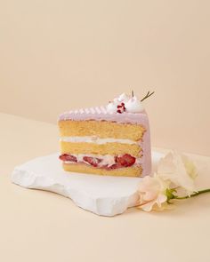 a piece of cake sitting on top of a white plate next to a pink flower