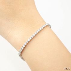 Classic diamond tennis bracelet in 14k solid gold offered in 2ct, 3ct, 4ct and 5ct. They are in stock ready to ship in 14k white gold in size 7. Diamond weight: 2ct (72pcs), 3ct (72pcs), 4ct (65pcs), 5ct (62pcs) Diamond color: H color Diamond clarity: SI clarity Cut: Very good Bracelet length: 7 Inch Material: Solid 14k white gold Classic diamond tennis bracelet in 14k solid gold offered in 2ct, 3ct, 4ct, and 5ct. Unlike many tennis bracelets with bulky settings, this setting flows nicely on you White Cubic Zirconia Jubilee Bracelet, White Jubilee Bracelet With Cubic Zirconia, White Jubilee Bracelet Jewelry With Cubic Zirconia, White Bracelet With Diamond Accents, White Diamond Accents Tennis Bracelet As Gift, Elegant White Tennis Bracelet With Prong Setting, White Tennis Bracelet With Diamond Accents As Gift, White Diamond-accented Tennis Bracelet As Gift, White Diamond Bracelet With Prong Setting