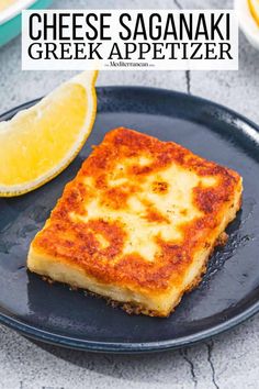 cheese saganaki greek appetizer on a black plate with lemon wedges