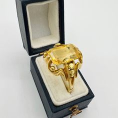 Antique Victorian 14k yellow gold ring with an emerald cut citrine gem. This is a beautiful unique piece that is a great state for its age. Jewelry box in the photos is not included. Precious Metals/Materials: 14k gold Weight: 5.38g Stones: Emerald Cut Citrine  Size:  8 US, 57 EU Era:  Victorian based on style and design Markings: None Heirloom Gold Topaz Ring With Rose Cut Diamonds, Gold Citrine Heirloom Rings, Victorian Gold Signet Ring With Gemstone, Antique Gold Signet Ring With Gemstone, Classic Gold Topaz Birthstone Ring, Fine Jewelry Yellow Gold Octagon Topaz Ring, Victorian Style Gold Emerald Ring With Rose Cut Diamonds, Antique Emerald Cut Yellow Gold Emerald Ring, Yellow Gold Octagon Topaz Ring Fine Jewelry