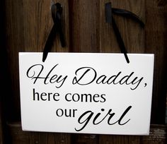 a sign that says hey daddy, here comes our girl hanging on a wooden door