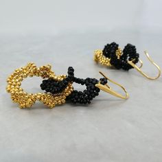 Knot hoop earrings crafted with black and gold seed beads are a striking accessory that exudes both elegance and boldness. These earrings are designed to make a statement, drawing attention with their intricate craftsmanship and the sophisticated contrast of colors. The combination of black and gold seed beads creates a dynamic visual effect, perfect for both formal occasions and stylish everyday wear. Crochet earrings have gained popularity for their unique texture and handmade appeal. The proc Seed Bead Hoop Earrings, Black Statement Earrings, Gold Knot Earrings, Beads Crochet, Best Girlfriend, Hoop Earrings Handmade, Gold Bead Earrings, Double Hoop Earrings, Boho Birthday