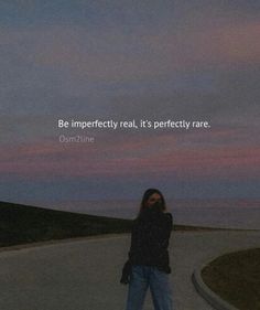 a woman standing in the middle of a road with a quote above her that reads be imperfectedly real, it's perfectly rare