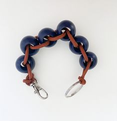 a bracelet with blue beads and metal hooks