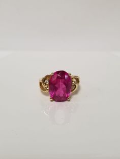 "Thanks for shopping our vintage estate store. We tend to sell well below wholesale and truly hope you enjoy all of our items. Many of the items are one of a kind, so please enjoy scrolling through the pictures and hopefully something will catch your eye. Spots are from reflections or camera. Estate 14k yellow gold created 6ct oval red ruby CZ .03ct Diamond cocktail filigree ring. No scratches on the gem. Stunning. Vintage setting, one that someone will love. Gem is testing natural, but it's created ruby. Size: 6 Setting: 1/2\" Band width: 2mm Weight:  4.89 grams Marked 14k. Gem is stunning." Oval Ruby Ring With Diamond Accents For Promise, Classic Oval Ruby Ring, Classic Oval Birthstone Ring With Diamond Accents, Oval Ruby Birthstone Ring With Diamond Accents, Pink Birthstone Ring For Formal Occasions, Formal Ruby Ring With Oval Cabochon And Accent Stones, Formal Oval Cabochon Ruby Ring With Accent Stones, Oval Ruby Ring With Diamonds In Gold, Classic Pink Ruby Ring For Formal Occasions