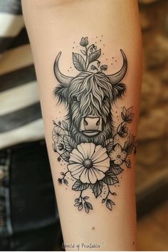 a black and white photo of a cow with flowers on it's arm,