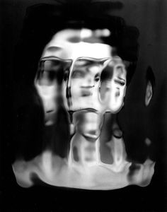 a black and white photo of three mannequins with their heads turned to the side