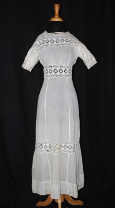 "EDWARDIAN FANCY TEA SUMMER DAY DRESS, 1910 Presenting a Edwardian snow white light weight sheer dotted swiss cotton summer tea day dress dating to the early 1900's to 1910. One piece in construction. This dress is for a tall woman. Short fitted sleeves with schiffli and valenciennes lace. The front bodice has a lovely wide white machine embroidered schiffli lace with open work motifs, with no collar. The bodice back has an extensive hook/eye closure extending into the skirt. Dress has no lining Summer Victorian Dress With Empire Waist, Regency Style Prairie Dress For Summer Garden Party, Regency Style Summer Prairie Dress For Garden Party, Summer Victorian Dress For Garden Party, Summer Regency Prairie Dress For Garden Party, Fitted Victorian Dress In Vintage White For Summer, Summer Victorian Dress In Vintage White, Summer Victorian Dress For Daywear, White Fitted Victorian Dress For Garden Party