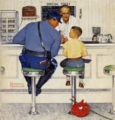 a man sitting at a counter with a baby in front of him