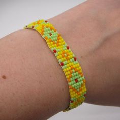 Bracelet Is Hand Beaded Using A Loom. Made With Yellow, Lime Green, Orange, And Red Czech Glass Beads. Silver Tone Ribbon Crimp Ends With A Lobster Clasp Closer. Light Weight, Great For All Day Wear. Add A Pop Of Color To Your Outfit! To Keep Your Bracelet In Great Shape, Avoid Water. And Dry Immediately If Contact Occurs. 6 - 7.5 Inches Long 1/2 Inches Wide Tiny Yellow Beads For Summer, Adjustable Yellow Beaded Friendship Bracelets, Adjustable Yellow Beaded Bracelets With Tiny Beads, Handmade Yellow Friendship Bracelets, Yellow Friendship Bracelets With Tiny Beads, Adjustable Yellow Friendship Bracelets For Festivals, Yellow Bracelets With Tiny Beads For Friendship, Adjustable Yellow Bracelet For Friendship, Adjustable Yellow Bracelets For Friendship