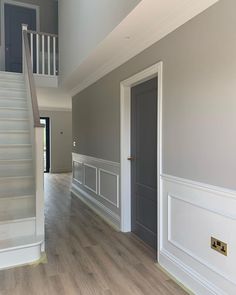 an instagram photo of a house with stairs and wood flooring in the background