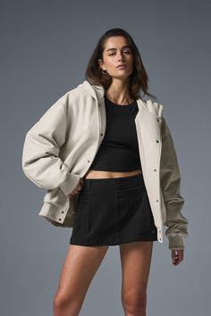 Everybody needs a bomber jacket—especially one like this, that can go from street to sleek in the blink of an eye. It has a slightly oversized fit that hits at the high hip with a heavyweight French terry body and lightly filled faux leather sleeves. The ribbed hem and cuffs keep cold air out, and it’s finished with matte snaps, side pockets and a wind-defying hood. Grab yours and get ready to wear it on repeat. Urban Oversized Varsity Jacket With Pockets, Oversized Urban Varsity Jacket With Pockets, Urban Oversized Varsity Jacket For Streetwear, Oversize Track Jacket For Fall Streetwear, Oversized Fall Track Jacket For Streetwear, Trendy Oversized Varsity Jacket With Ribbed Cuffs, Alo Yoga Winter Outerwear With Ribbed Cuffs, Oversized Hooded Urban Varsity Jacket, Oversized Hooded Varsity Jacket With Pockets