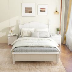 a white bed sitting in a bedroom on top of a hard wood floor next to a window