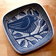 a blue and white plate sitting on top of a wooden table