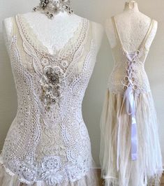 two mannequins dressed in white lace and beaded garb with bows