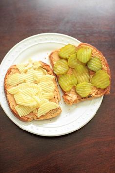 two pieces of bread with pickles on it