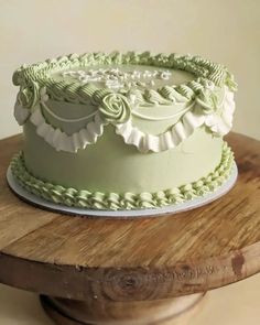 a green cake sitting on top of a wooden table