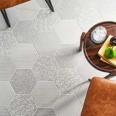 a table with two chairs and a drink on it in front of a tiled floor