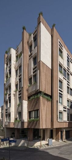 an apartment building with plants growing out of the windows