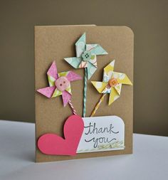 a thank you card with paper flowers and pinwheels attached to the back of it