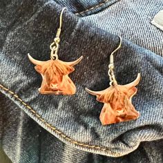 Exquisitely crafted from premium materials, these Highland Cow Earrings add a luxurious, elegant touch to any outfit. Featuring a delicate fish hook and 1.5" dangle, this beautiful homage to nature will complete your fashionable ensemble with a timeless touch. Cow Earrings, Highland Cow, Fish Hook, Cow, Fish, Nature