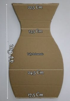 the height of a cardboard dress is shown with measurements for each piece in front of it