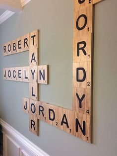 scrabble tiles are arranged on the wall to spell words