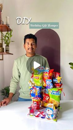 a man standing in front of a pile of snacks