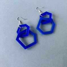 Royal blue geometric acrylic earrings that are light and easy to wear. A two link geometric design that is eye-catching and interesting.  These earrings compliment the royal blue  necklaces in my shop to make a perfect matching set. They have a 7cm drop and are 4cm wide and finished with silver plated hook fittings. Presented in a black organza drawstring bag wrapped in black tissue and tied with white ribbon, ready for gifting. Free delivery by 1st class Royal Mail. Blue Geometric Jewelry As A Gift, Contemporary Blue Earrings For Gift, Hexagon Blue Jewelry Gift, Blue Geometric Jewelry For Gifts, Bright Blue Earrings, Elegant Blue Geometric Jewelry, Modern Blue Geometric Jewelry, Modern Geometric Blue Jewelry, Blue Geometric Earrings