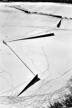 an aerial view of snow covered ground with arrows pointing in the direction of opposite directions