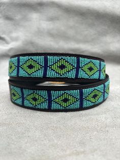 The Belts are made from ethically sourced leather in Kenya. The collars are then hand beaded by Maasai women artisans from my Village in Kajiado who have mastered the art. The hardware is made from 100% recycled brass. TO MEASURE CORRECTLY If you know your pants waist size, you can follow the add-two-inches rule i.e if your pants waist measurement is 32 Inches, then your belt size will be 34-36 Inch Belt. Our measurements are from the tip of the Buckle of the Belt to the second hole after the be Mens Beaded Belt Patterns, Beaded Belt Buckle, Zulu Beaded Belt, Traditional Leather Belt Buckle, Adjustable, Adjustable Brown Beaded Belt, Boho Belt, Belt Men, Handmade Belt, Boho Belts