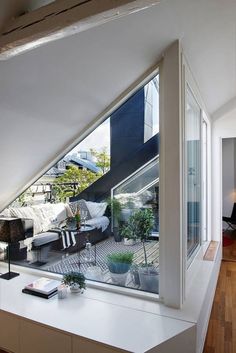 a living room filled with furniture next to a window